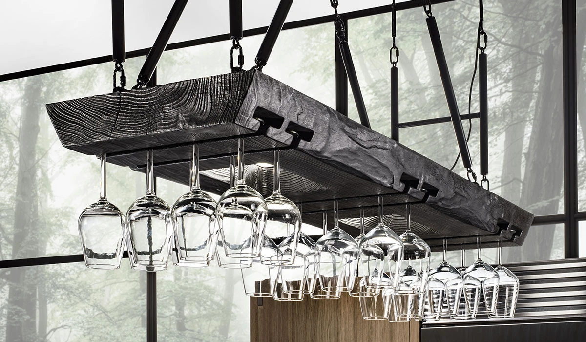 wine glasses washed with a Cove dishwasher, hanging from ceiling rack